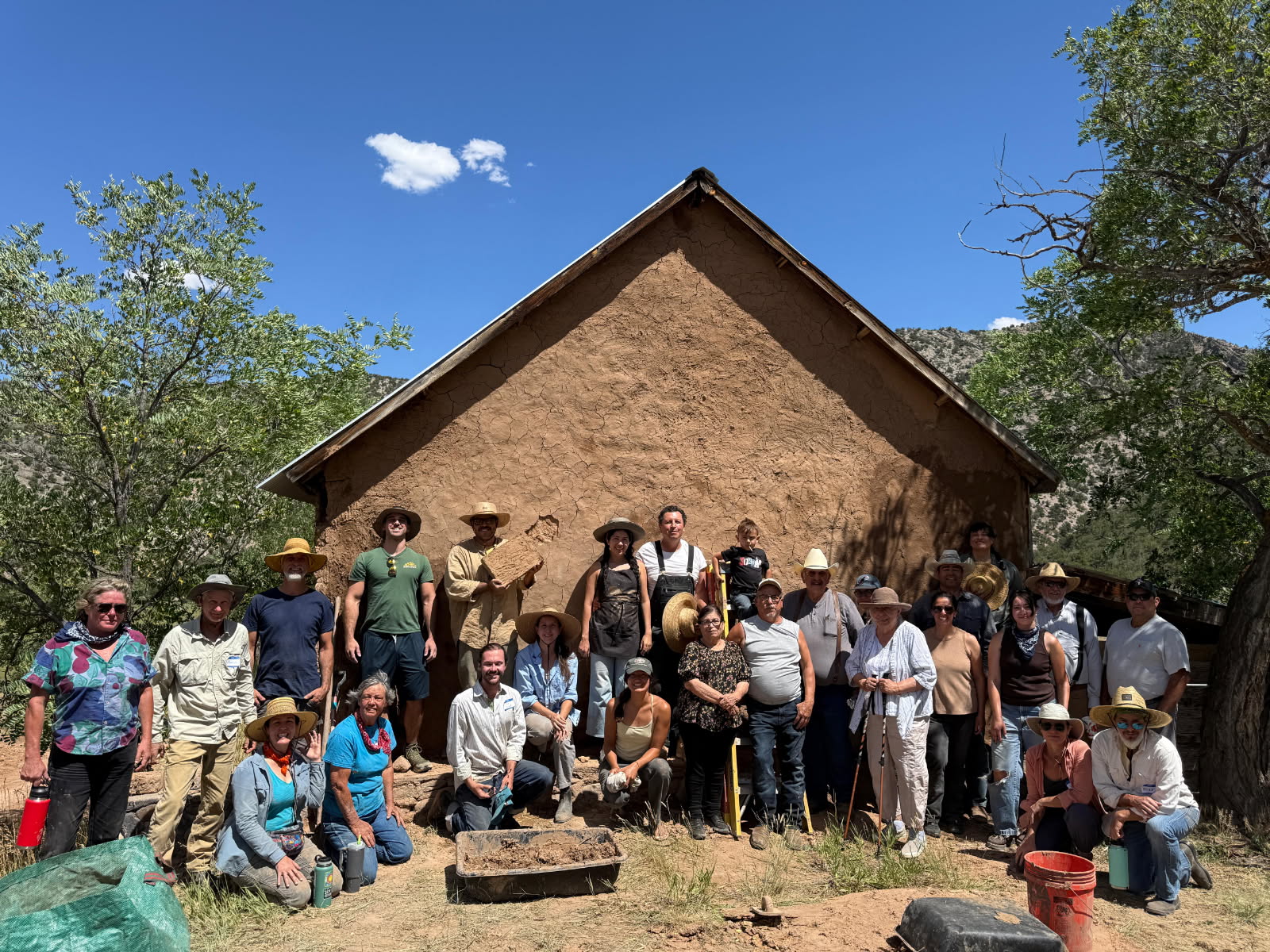 Adobe workshop participants working with mud and clay